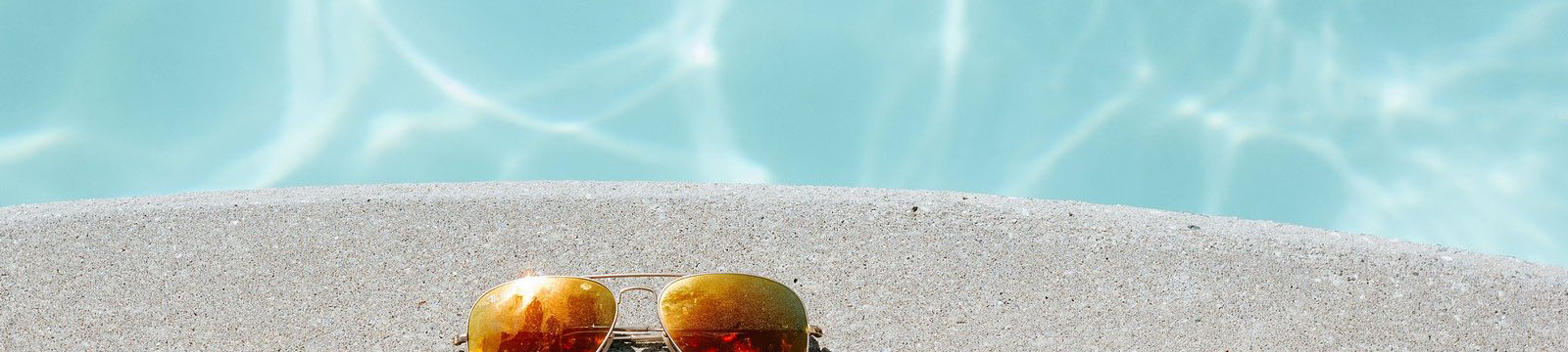 photo of swimming pool and sunglasses